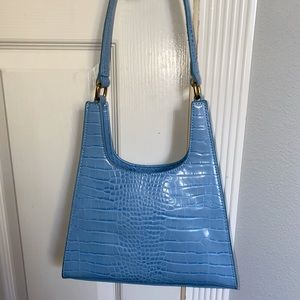 blue leather handbag crescent shaped